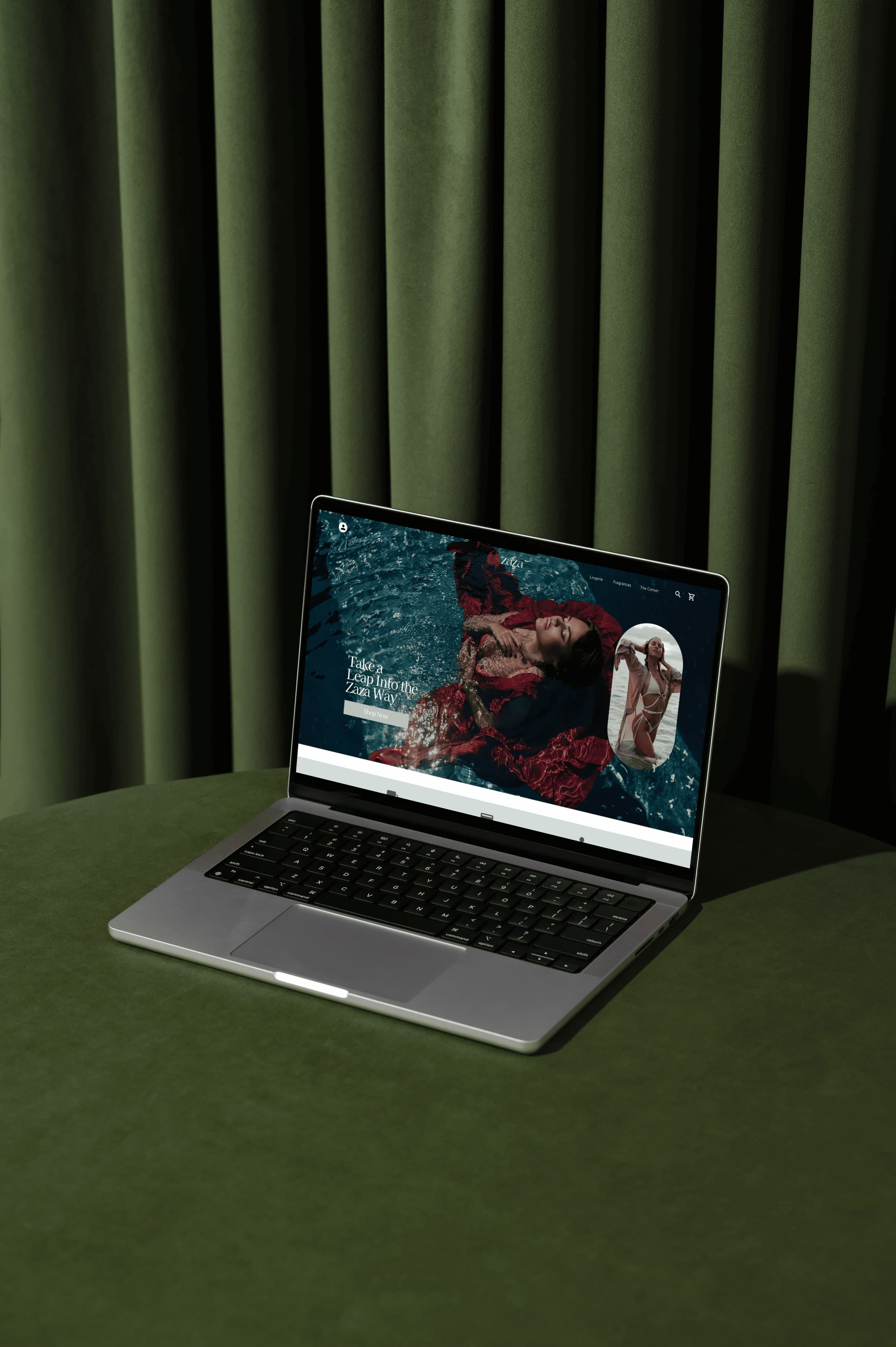 laptop on cushion with green curtain behind