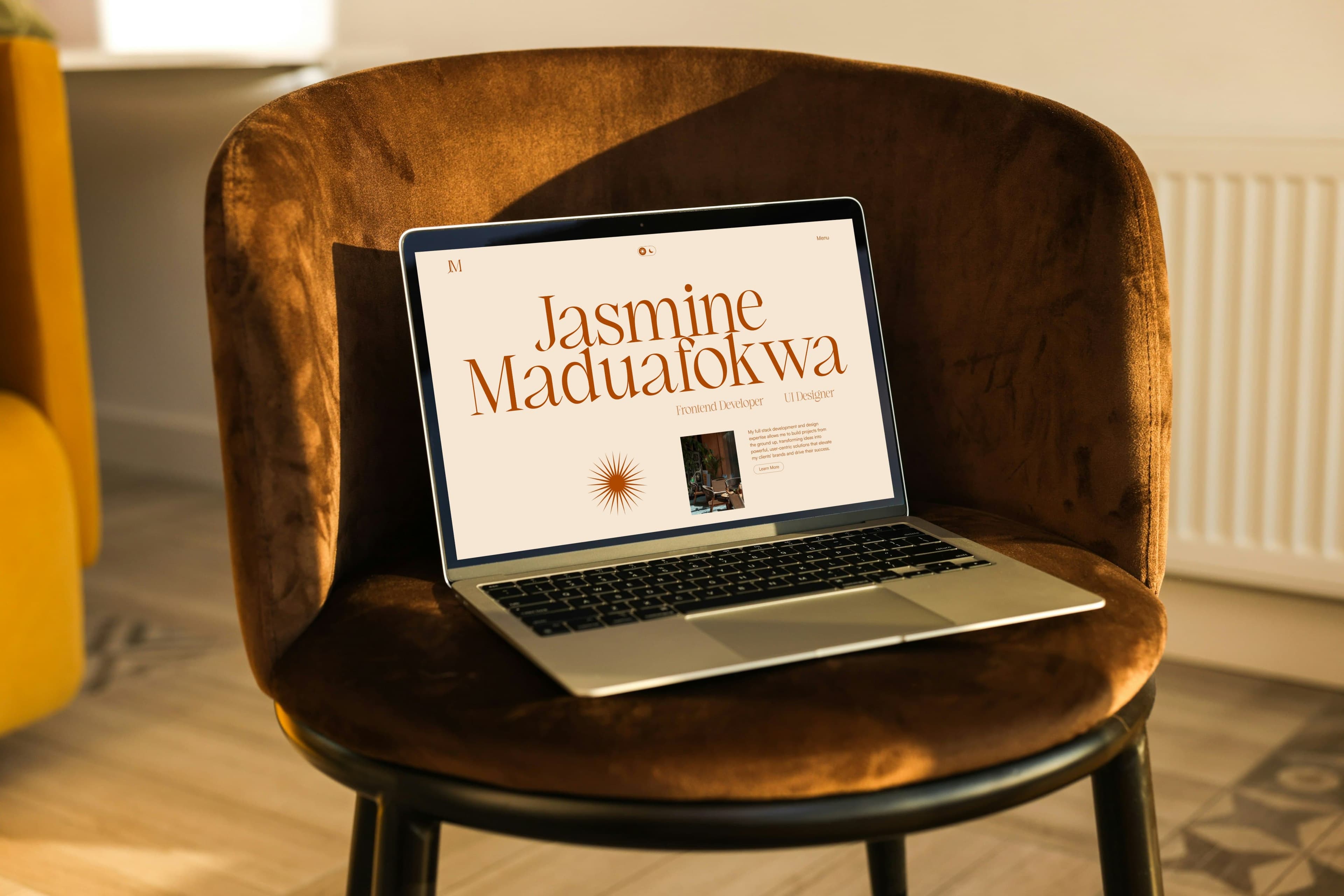 laptop on a brown suede chair